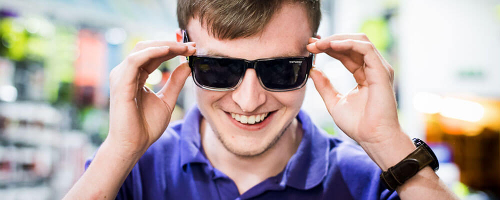 PR photography - man putting on sunglasses