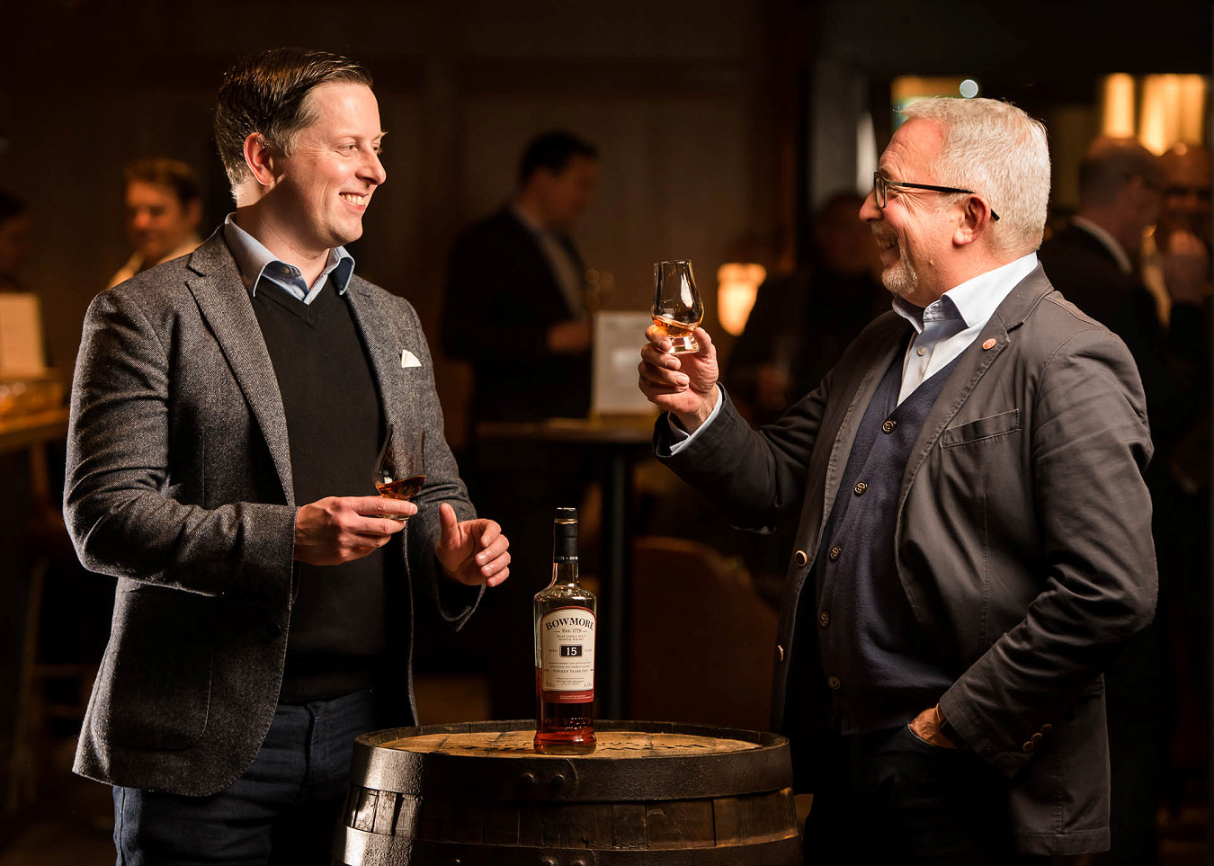 Two master distillers smiling while drinking a Bowmore whisky