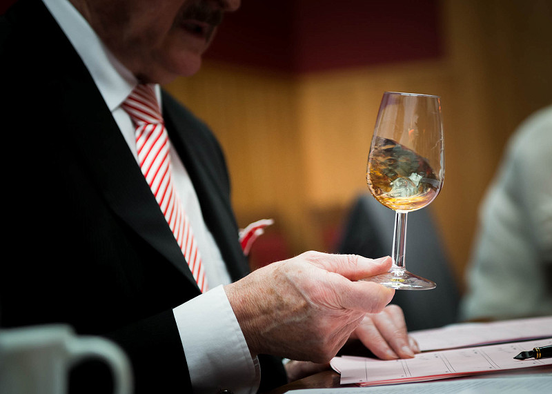 Close up photo of whisky being swirled around a copita whisky glass