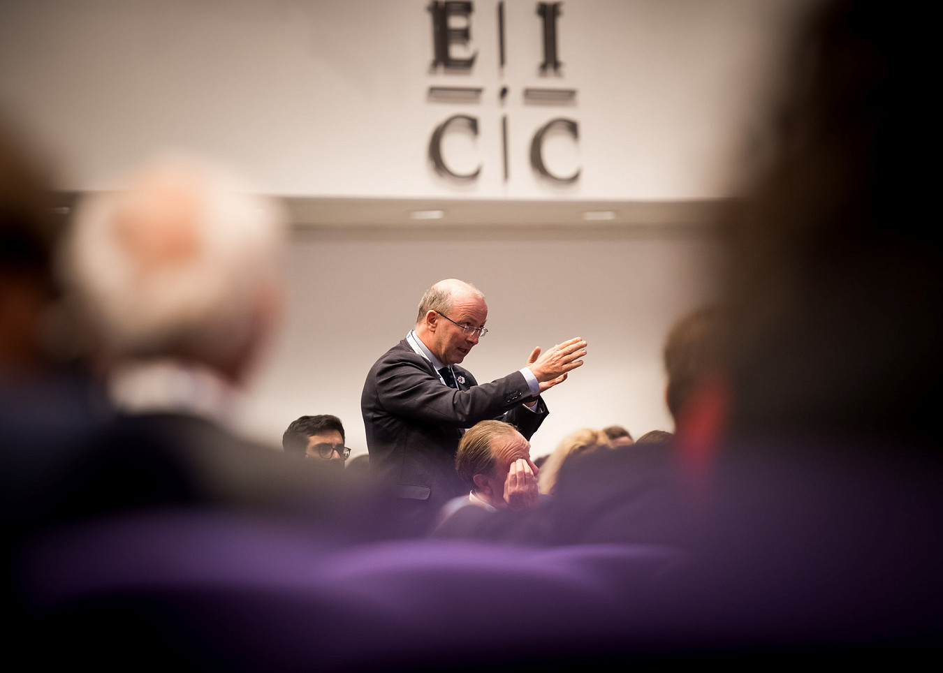 Wide angle of man holding a microphone and asking a question at a business conference at the EICC