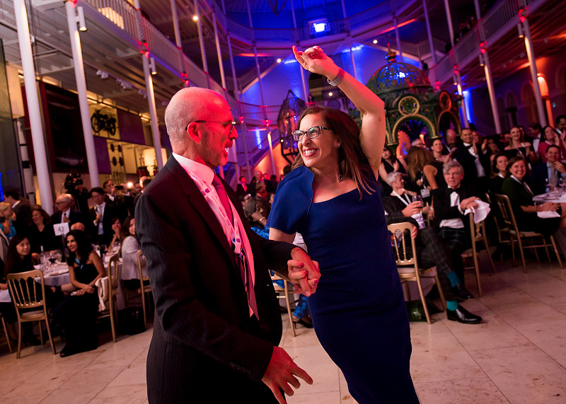 Woman and man dance together at a conference evening event at the National Mueum in Edinburgh
