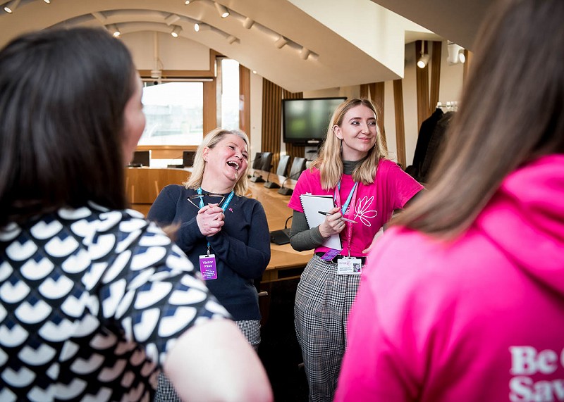 Event staff laughing with MSPs at Scottish Parliament