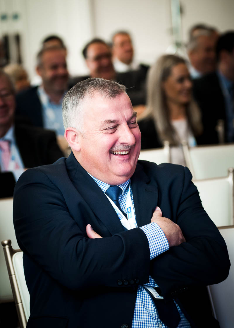 Laughing man at business conference