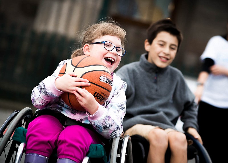 Girl in wheelchair playing basketball