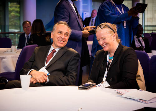 Man and woman smiling at a conference