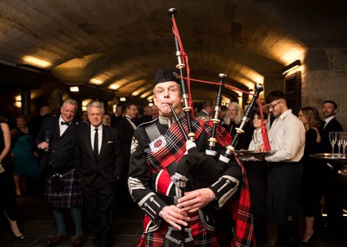 Piper in highland dress playing at a business event