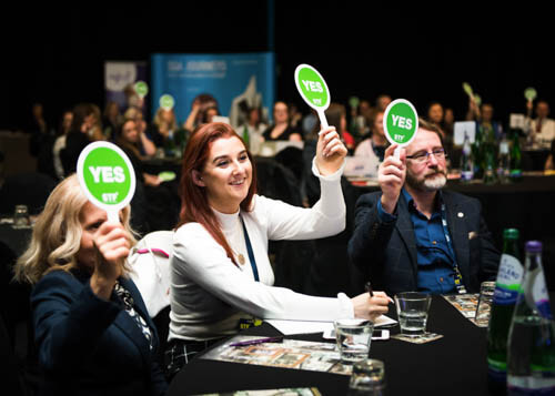 People holding up signs at a business conference